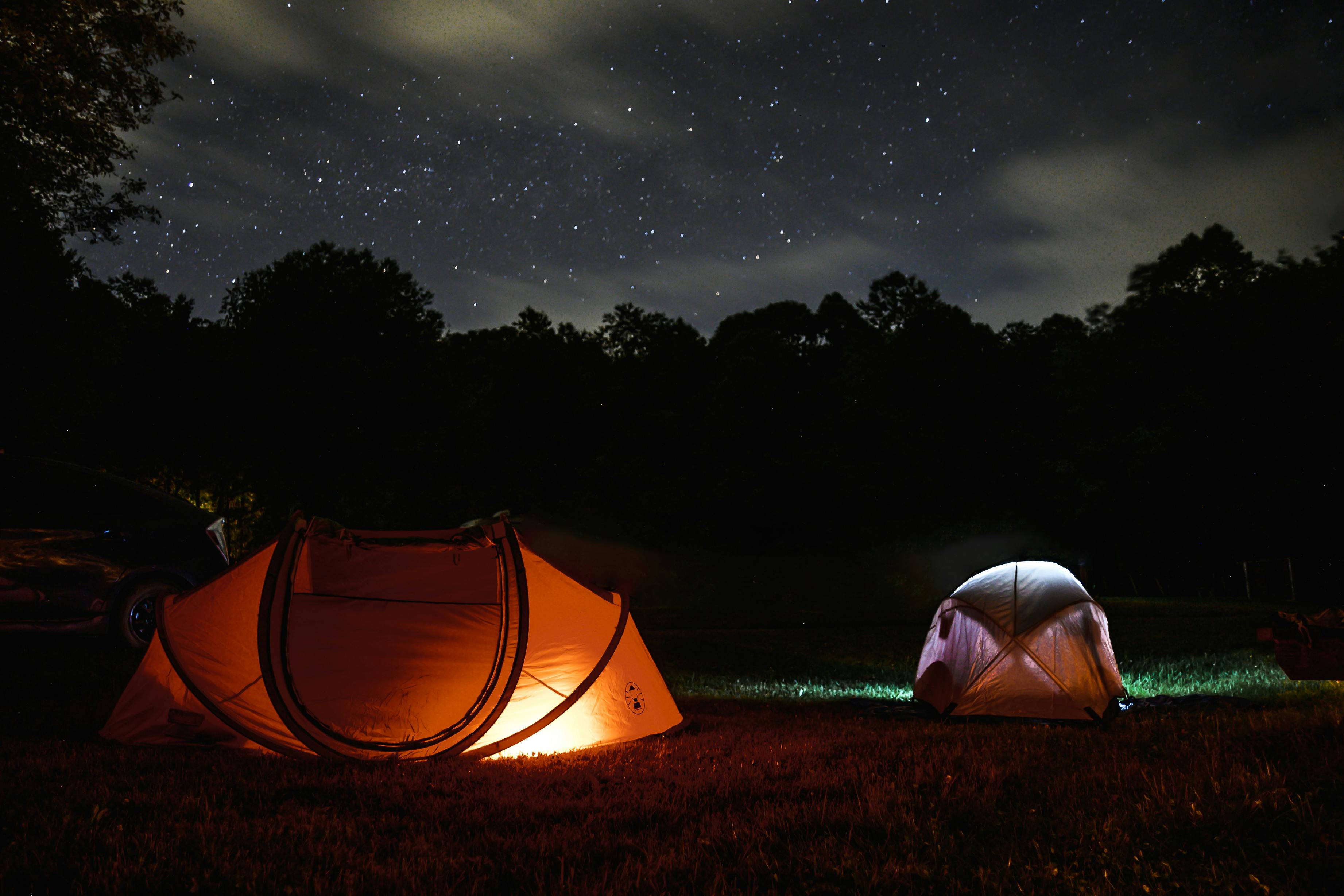 Two glowing tents on a beautiful starlit night